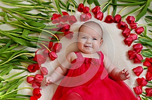 Cute baby girl with flower tulip