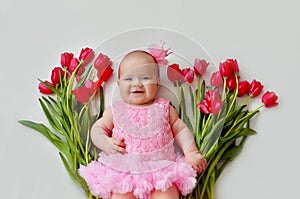 Cute baby girl with flower tulip