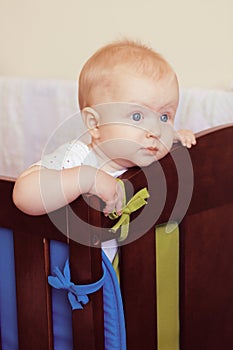 Cute baby girl in her crib