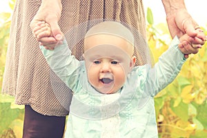 Cute Baby Girl Holding Mothers Hands Walking