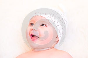 Cute Baby Girl Laughing and Wearing a Soft Knit Bear Ears Hat