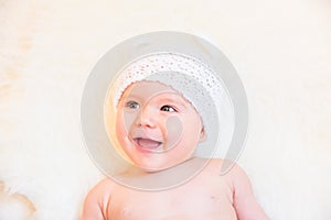 Cute Baby Girl Laughing and Wearing a Soft Knit Bear Ears Hat