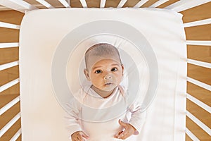 Cute Baby Girl Lying in the Crib