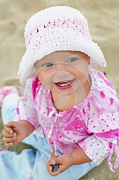 Cute baby girl playing on the beach