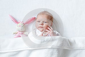 Cute baby girl playing with plush animal toy