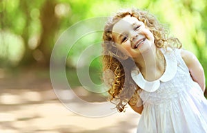 Cute baby girl shone with happiness, curly hair