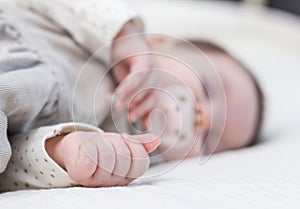 Cute baby girl sleeping over white bedcover