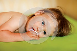 Cute baby girl with a soother in her mouth