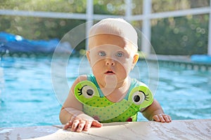 Cute Baby Girl in Swimming Pool on Summer Day