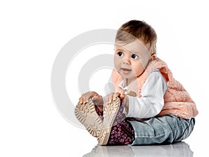 Cute baby girl touching new trendy shoes portrait