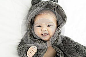 A Cute baby girl on a white bed at home