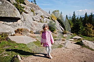 Cute baby girll in mountains. Little discoverer