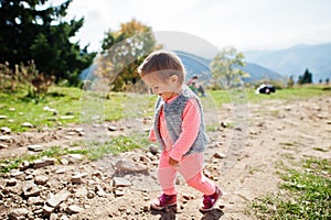 Cute baby girll waliking in mountains. Little discoverer