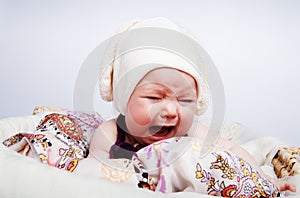 Cute baby in the hat crying out loud