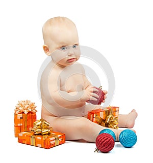 Cute baby holds red ball, christmas gift box