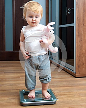 Cute baby on home scales