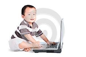 Cute baby and laptop computer