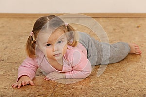 Cute baby lying on floor.