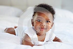 Cute Baby Lying On Tummy In Parent's Bed photo