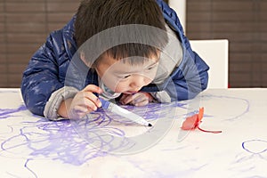 Cute baby is painting a flower