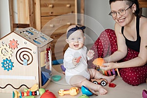 Cute baby plays with mom and rejoices. Family portrait Mom and Baby.