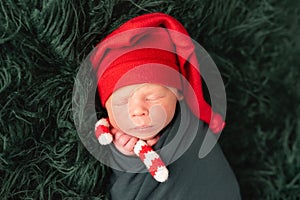 Cute baby in red santa hat sleeping