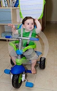 Cute Baby riding a tricycle