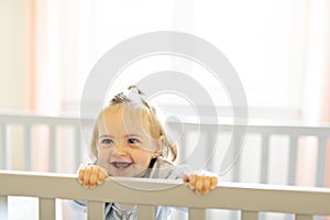 Cute baby baby on the baby room crib photo