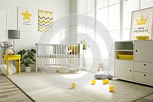 Cute baby room with crib and big window