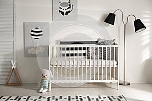 Cute baby room with crib and decor elements