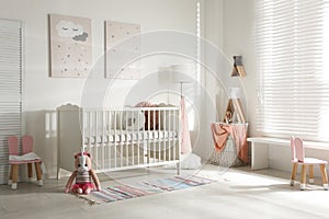 Cute baby room with crib and decor elements