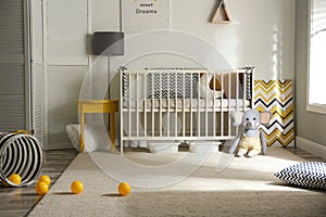 Cute baby room with crib and decor elements