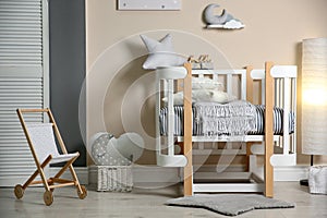 Cute baby room interior with modern crib and toys