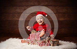 Cute Baby Santa Claus Happy Smiling sitting with Christmas Presents