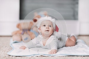 Cute baby in Santa`s hat on Christmas eve.