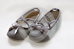 Cute baby shoes against a white background. Anticipating the arrival of a little girl and ready to play dress up with