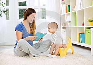 Cute baby sitting on bedpan and listening kid story