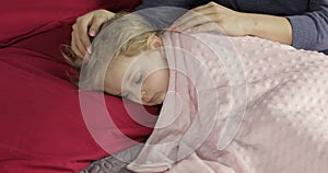 Cute baby sleeping on the bed at home. Little girl sleeping in morning light