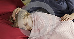 Cute baby sleeping on the bed at home. Little girl sleeping in morning light