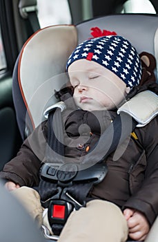 Cute baby sleeping in car seat