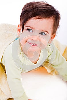 Cute baby smile under yellow blanket