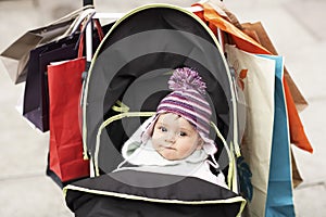 Cute Baby In Stroller Hung With Shopping Bags