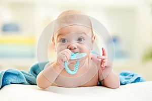 Cute baby with teether toy after bathing