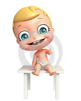 Cute baby with Thums up pose sitting on table photo