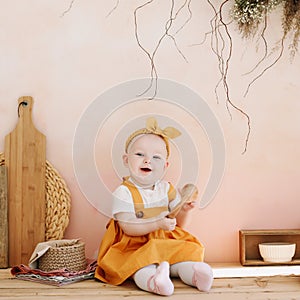 Cute baby toddler girl playing with eco-friendly wooden toys and having fun. Funny little baby girl playing in the kitchen.