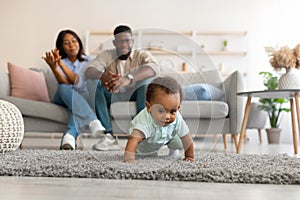 Cute baby toddler walking in living room making first steps