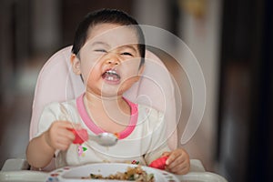 Cute baby try to eating by herself