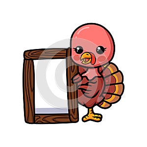 Cute baby turkey cartoon with wooden board