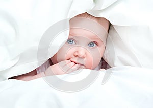 Cute baby under a blanket