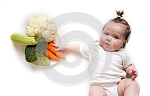 Cute baby and vegetable mix - broccoli, zucchini, carrots and cauliflower on white backround